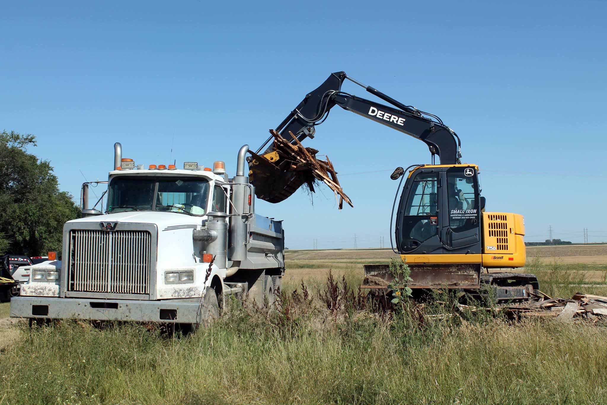 Restoration Experts working at material, sloped for drainage and seeded